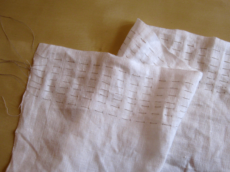 The apron with gathering stitches.